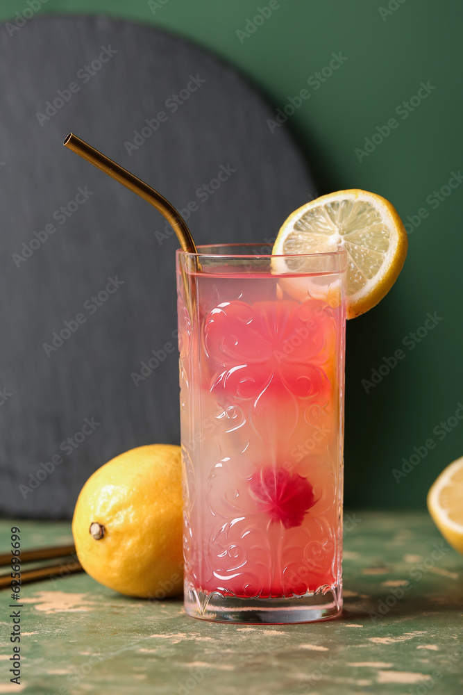 Glass of tasty mai tai cocktail on green background