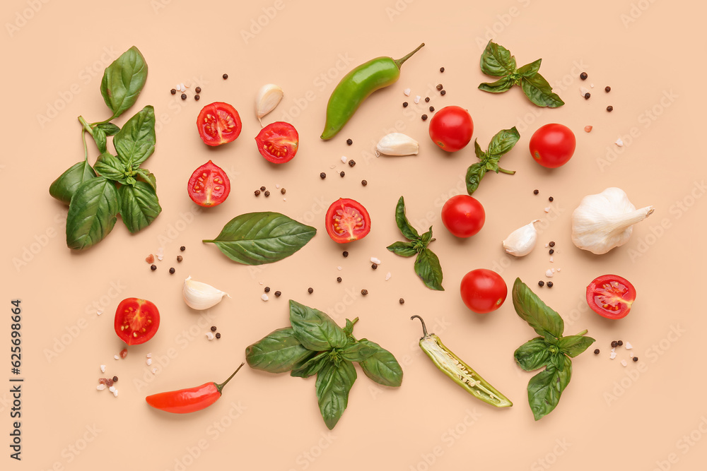 Fresh basil, cherry tomatoes and peppercorn on orange background