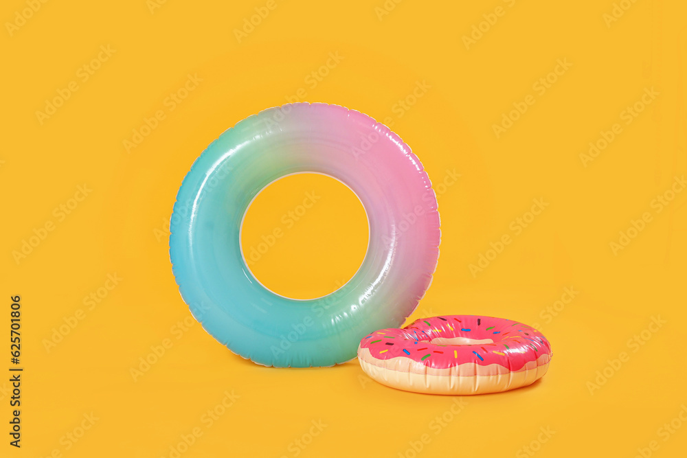 Inflatable rings on yellow background