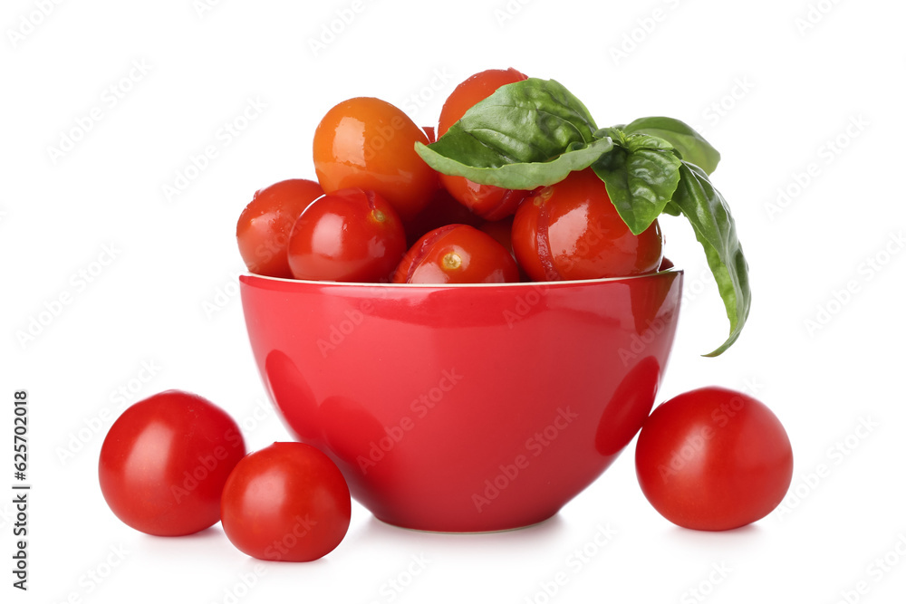 Bowl with canned tomatoes and basil on white background