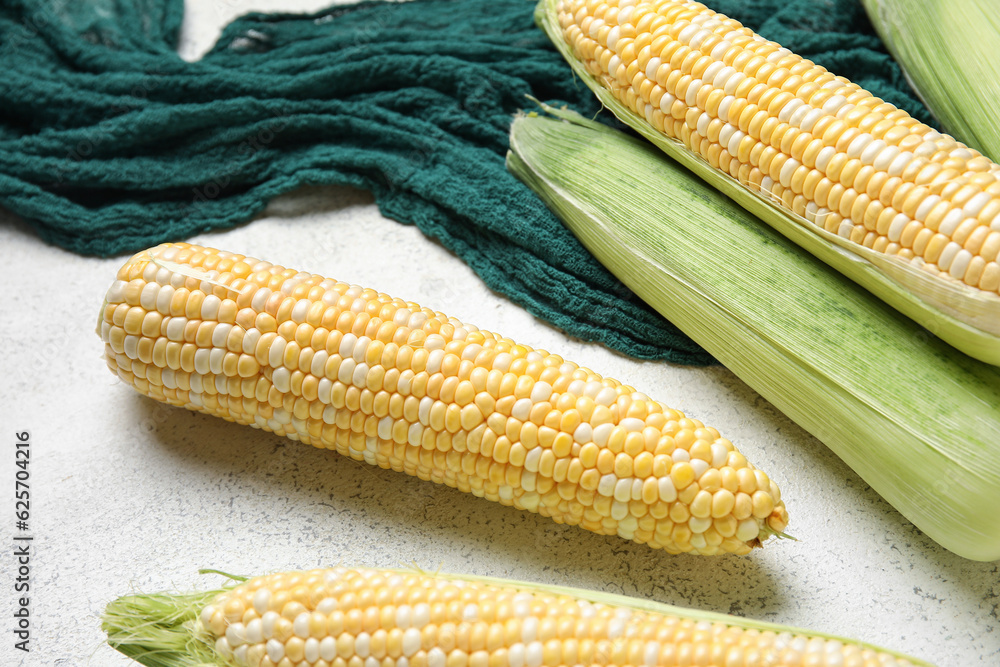 Fresh corn cobs on light background