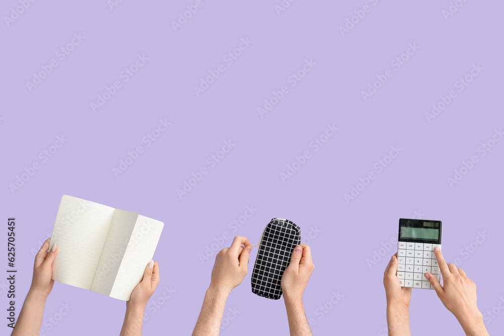 Hands with school supplies on lilac background