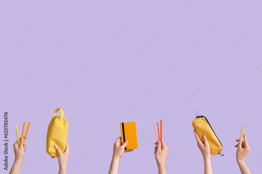 Hands with school supplies on lilac background