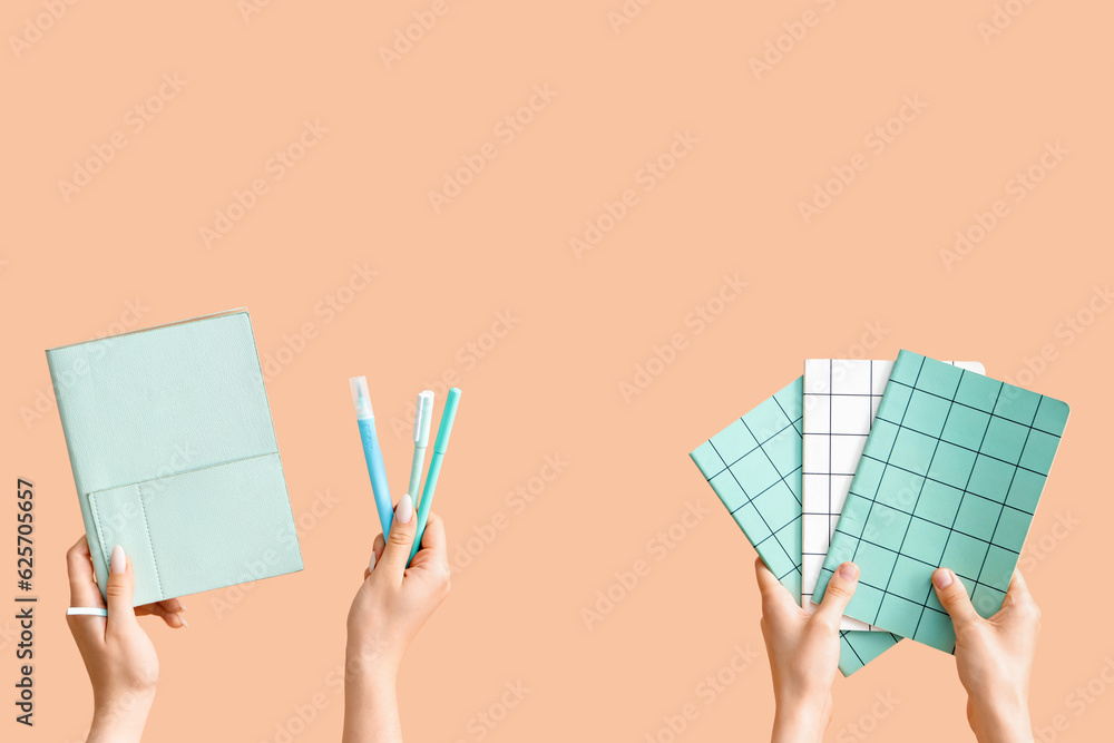 Female hands with school supplies on beige background