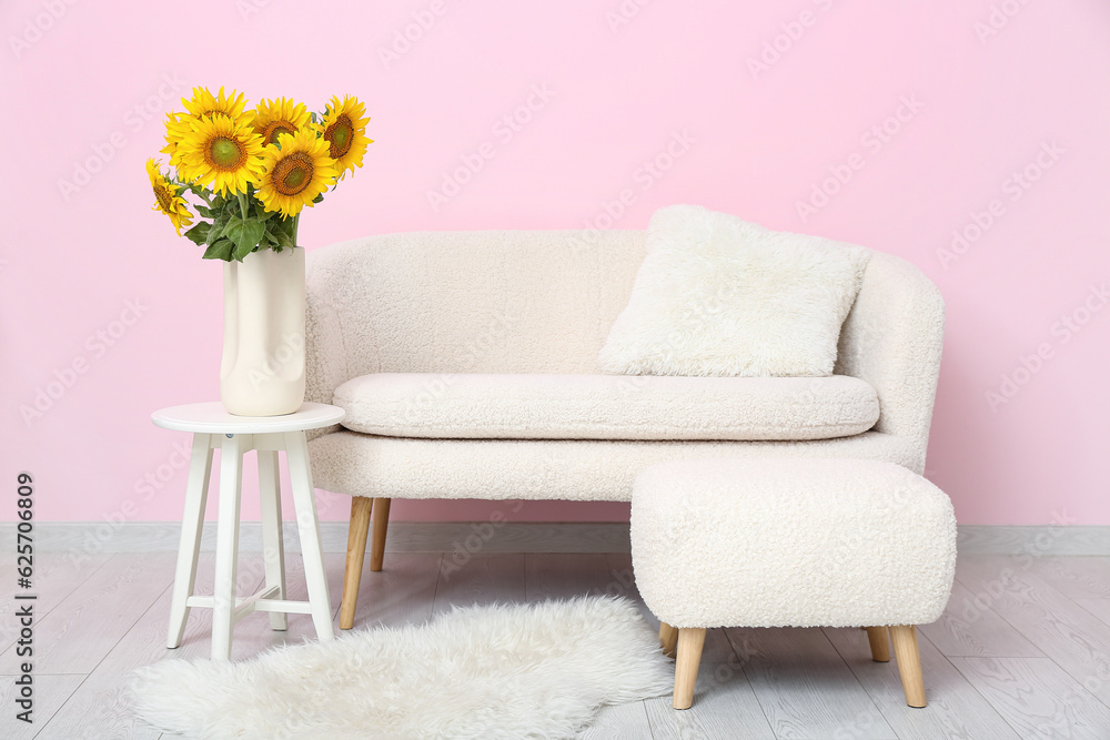 Interior of living room with sunflowers in vase on table