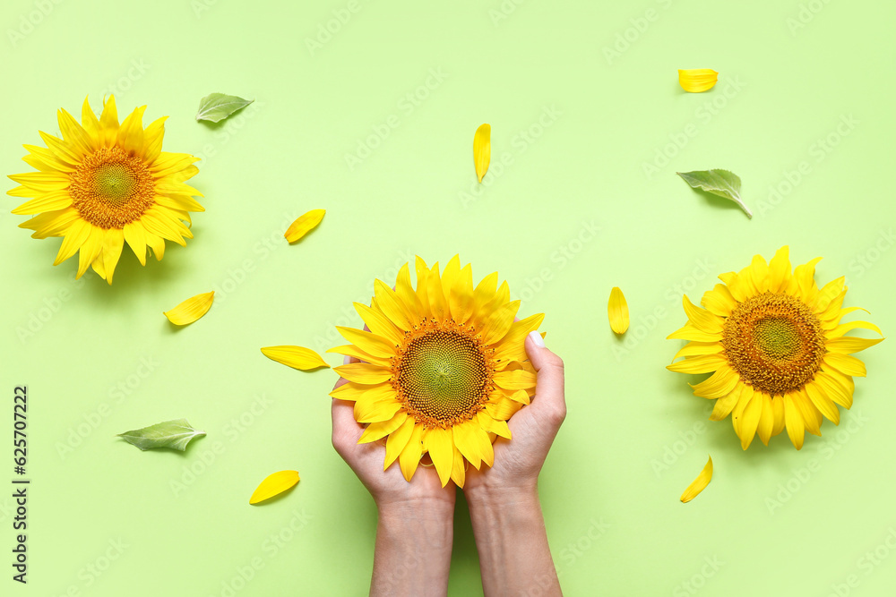 Woman with sunflowers on green background