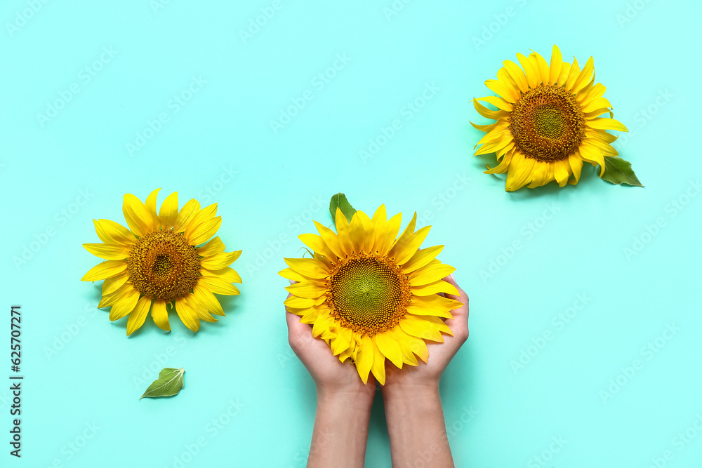 Woman with sunflowers on mint background