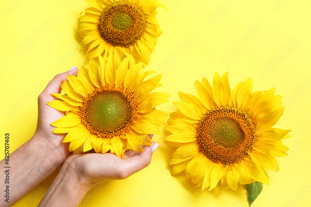 Woman with sunflowers on yellow background