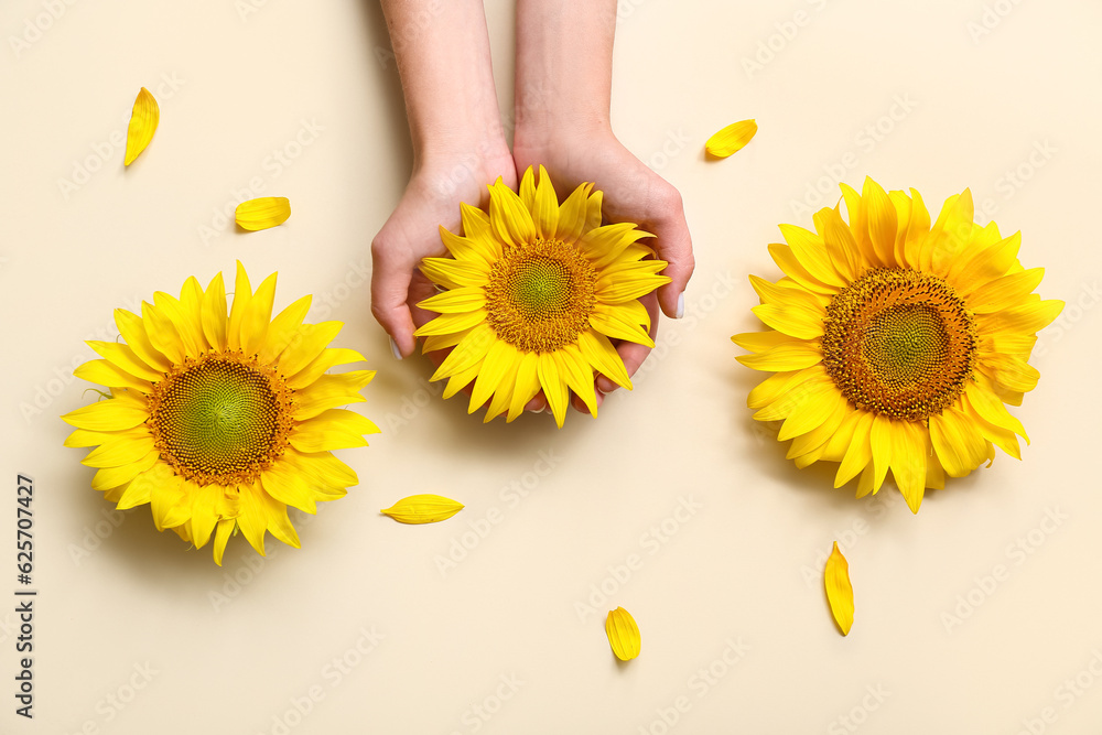 Woman with sunflowers on beige background