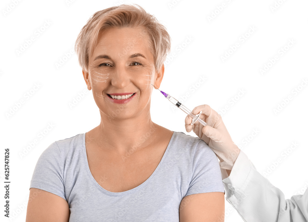 Mature woman receiving filler injection on white background, closeup