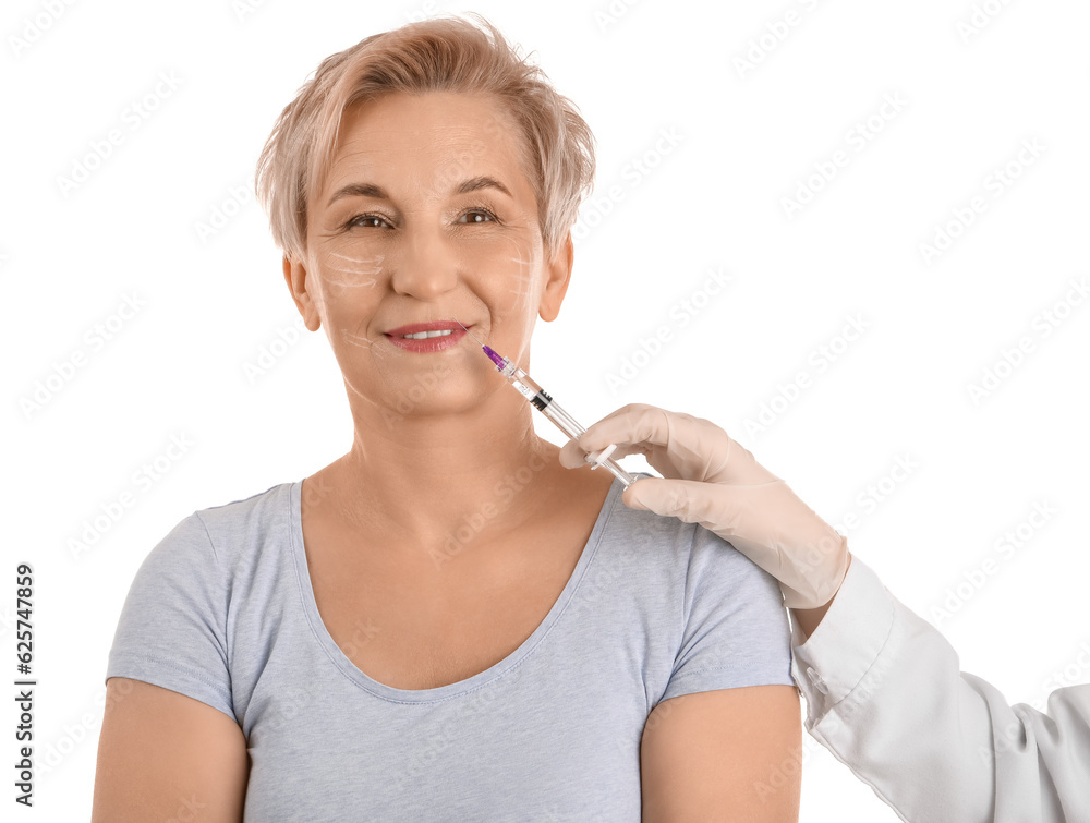 Mature woman receiving lip filler injection on white background, closeup