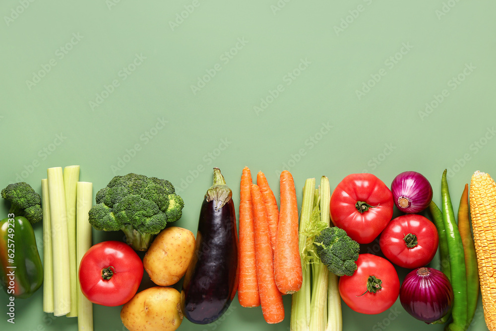 Different fresh vegetables on green background