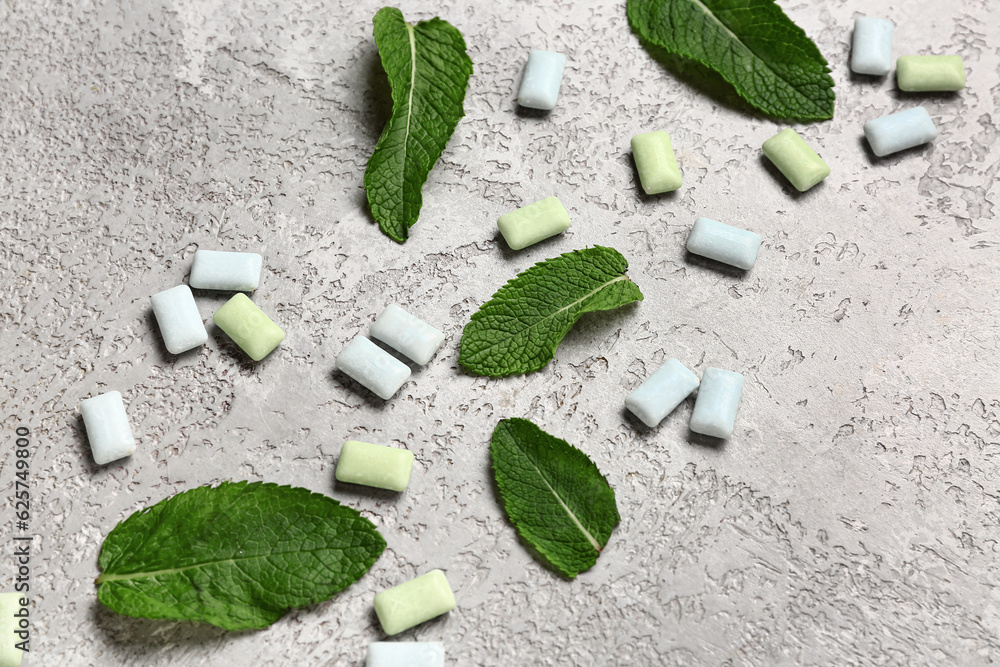 Fresh chewing gums with mint on grey background