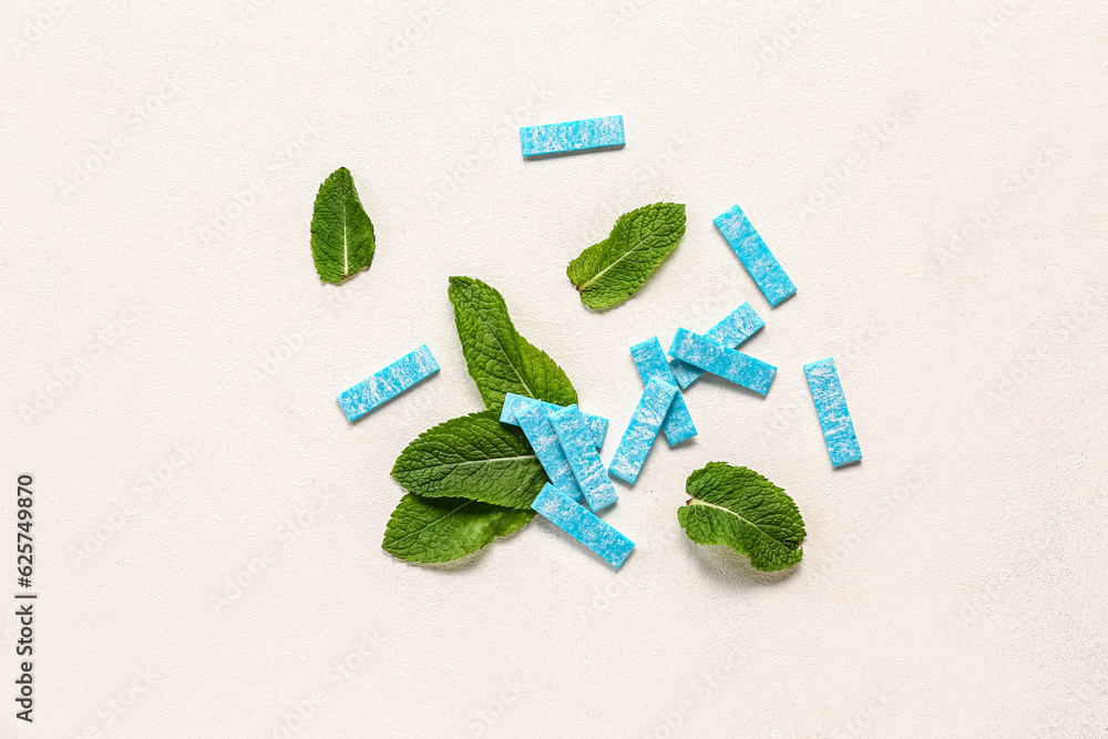 Fresh chewing gums with mint on white background