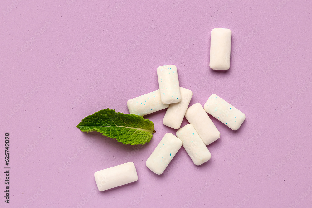 Fresh chewing gums with mint on lilac background