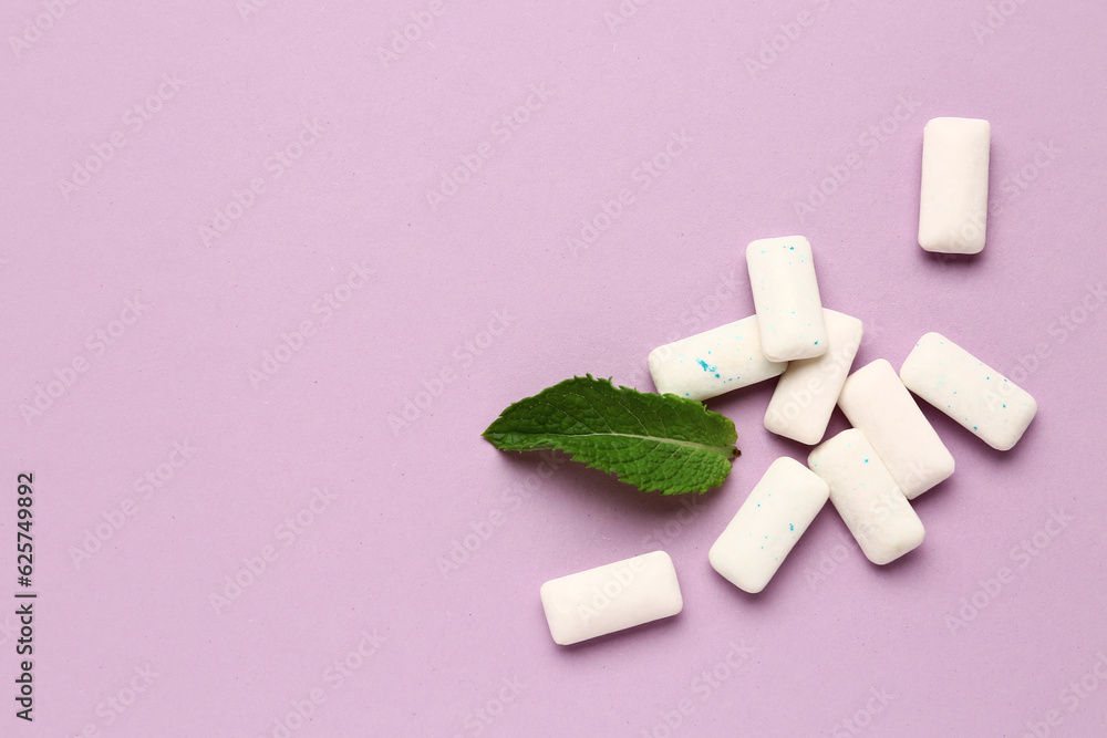 Fresh chewing gums with mint on lilac background