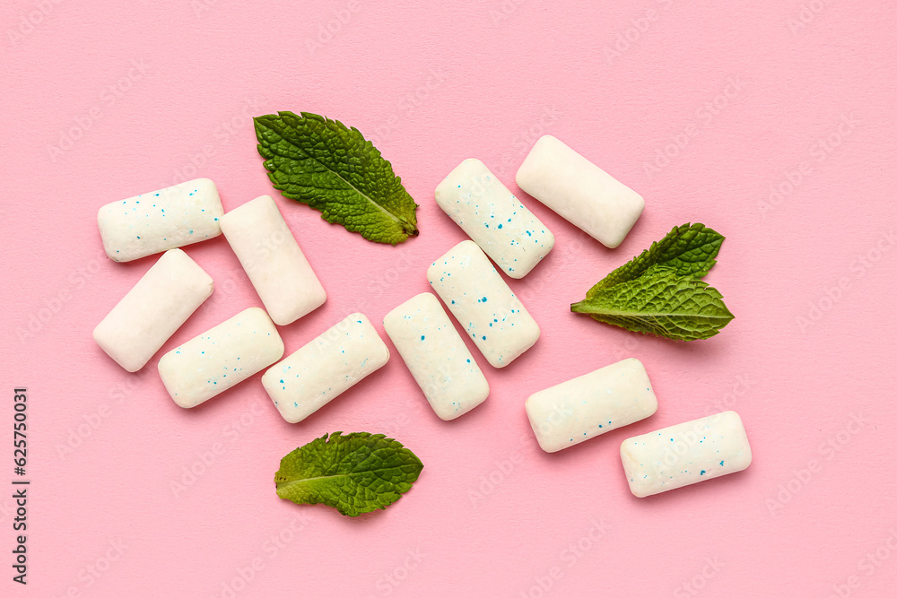 Fresh chewing gums with mint on pink background