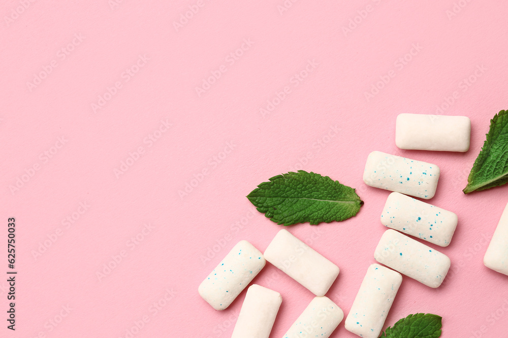 Fresh chewing gums with mint on pink background