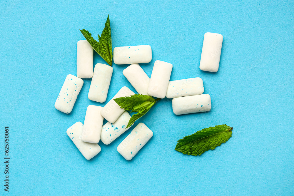 Fresh chewing gums with mint on blue background