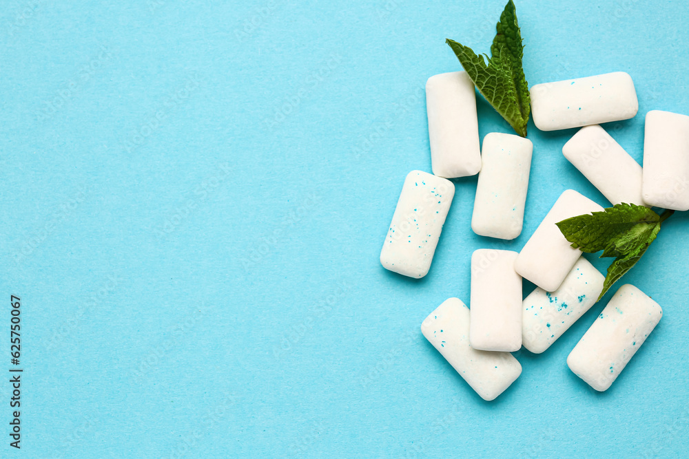 Fresh chewing gums with mint on blue background