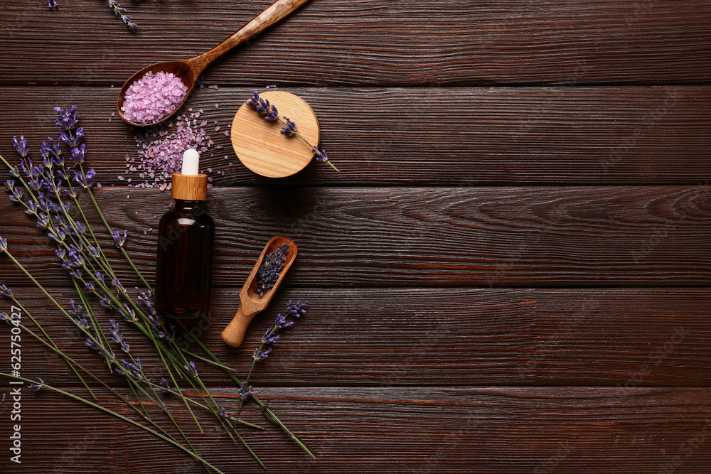 Composition with cosmetic products and aromatic lavender flowers on wooden background