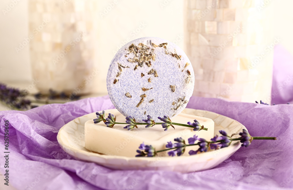 Composition with soap bars and lavender flowers on light background