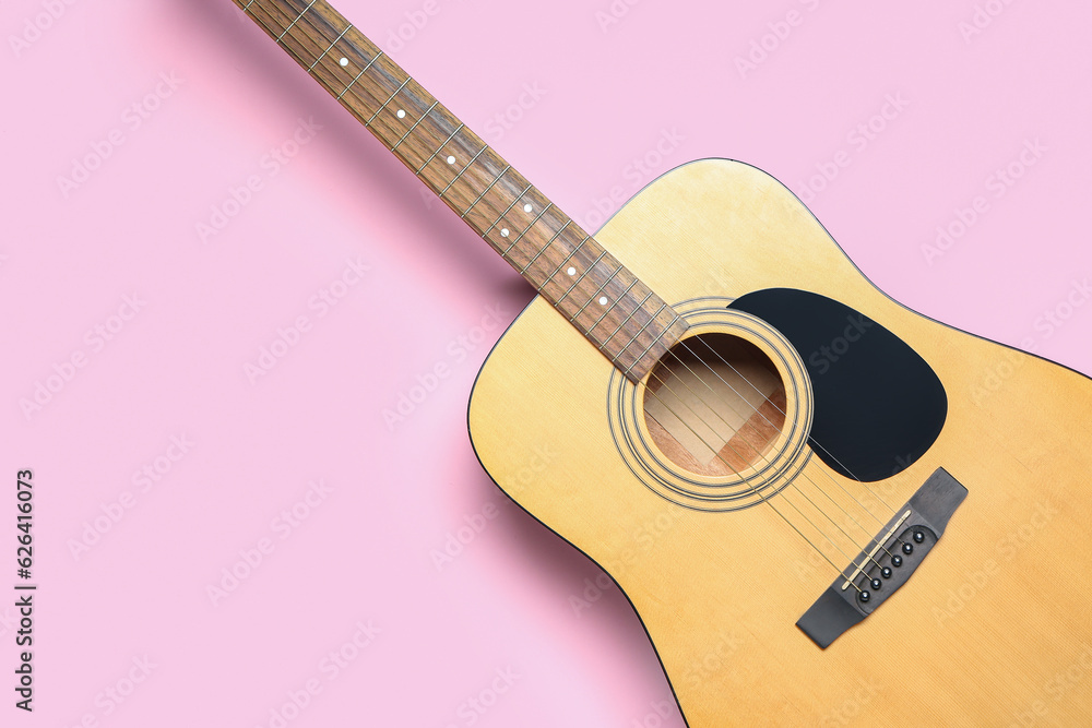 Acoustic guitar on color background