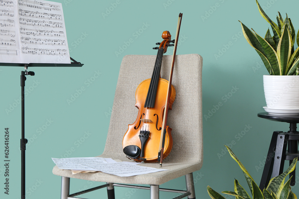 Chair with violin and note stand in room