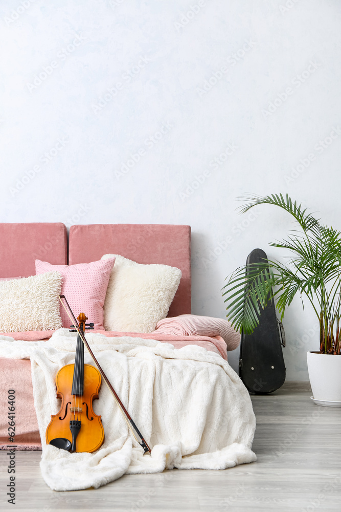 Interior of modern bedroom with violin