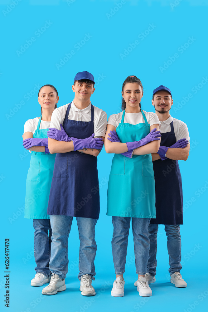 Young janitors on blue background