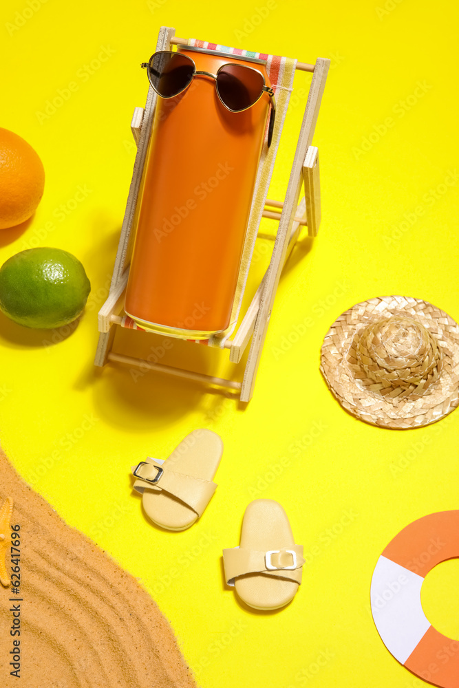 Can of soda with beach decor and citrus fruits on yellow background