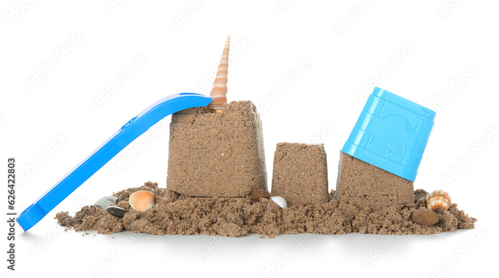 Castles made of sand with beach toys isolated on white background