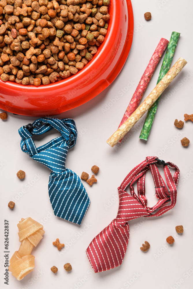 Composition with different dog food and accessories on light background