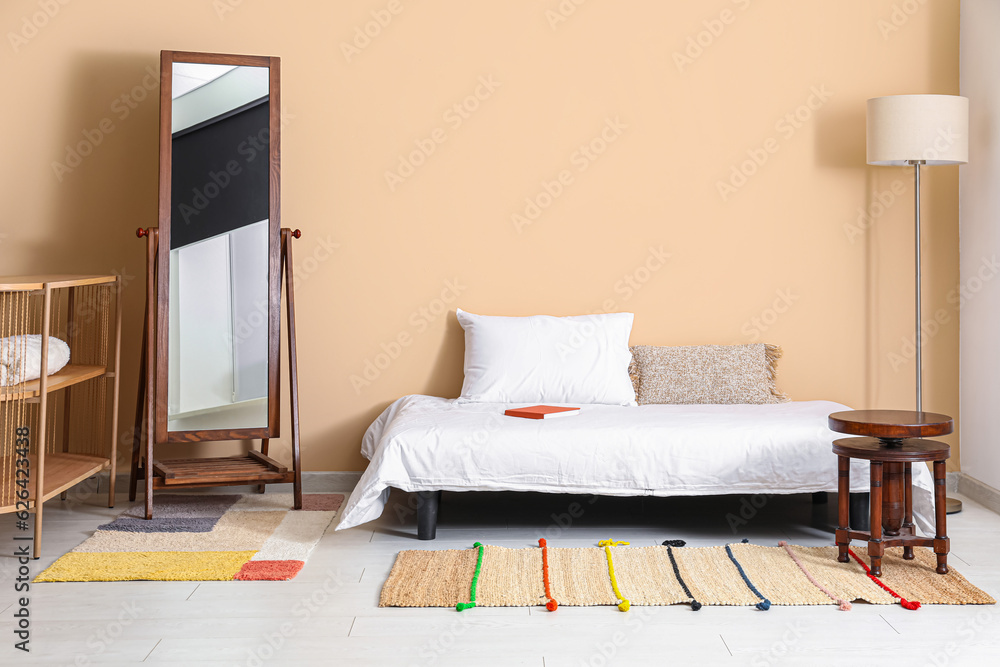 Interior of bedroom with cozy bed and stylish rug