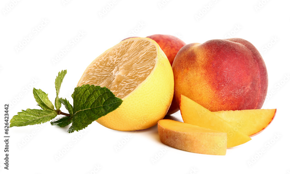 Fresh peaches, lemon and mint on white background