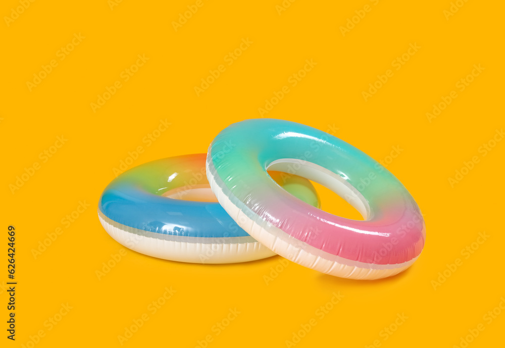 Inflatable rings on yellow background