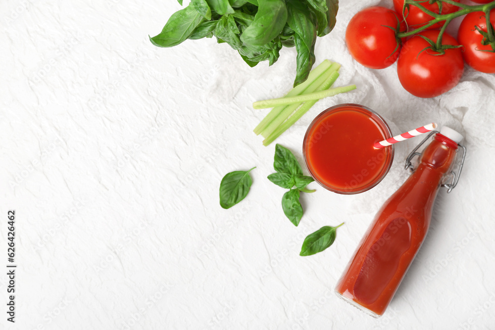 Glass and bottle of tasty tomato juice on white background