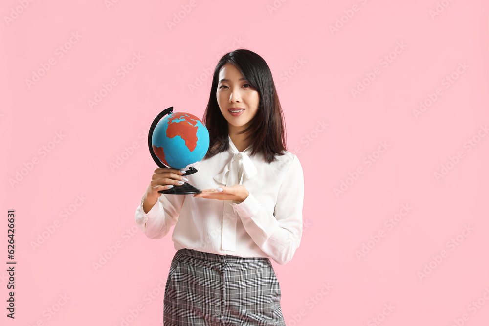 Asian Geography teacher with globe on pink background