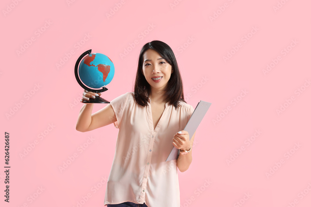 Asian Geography teacher with globe on pink background