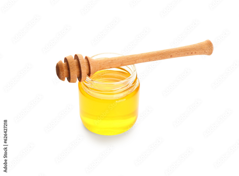 Jar of sweet honey and dipper on white background