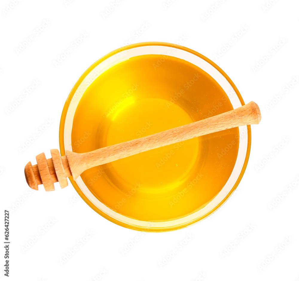 Glass bowl of sweet honey and dipper on white background