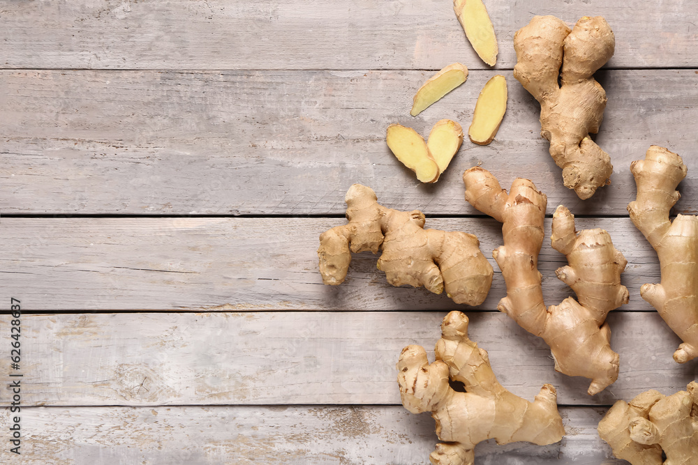 Fresh ginger roots on grey wooden background