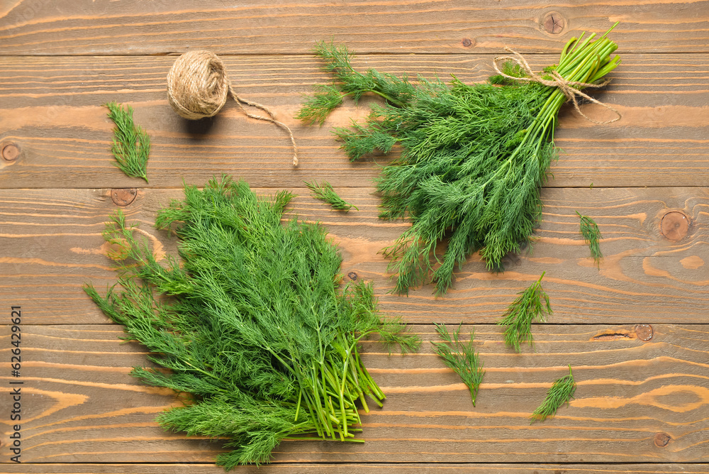 Fresh dill on wooden background