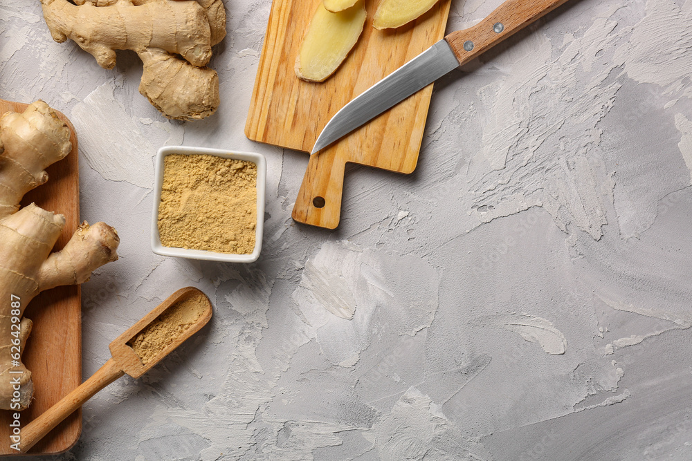 Fresh ginger roots and bowl with dried powder on grey background