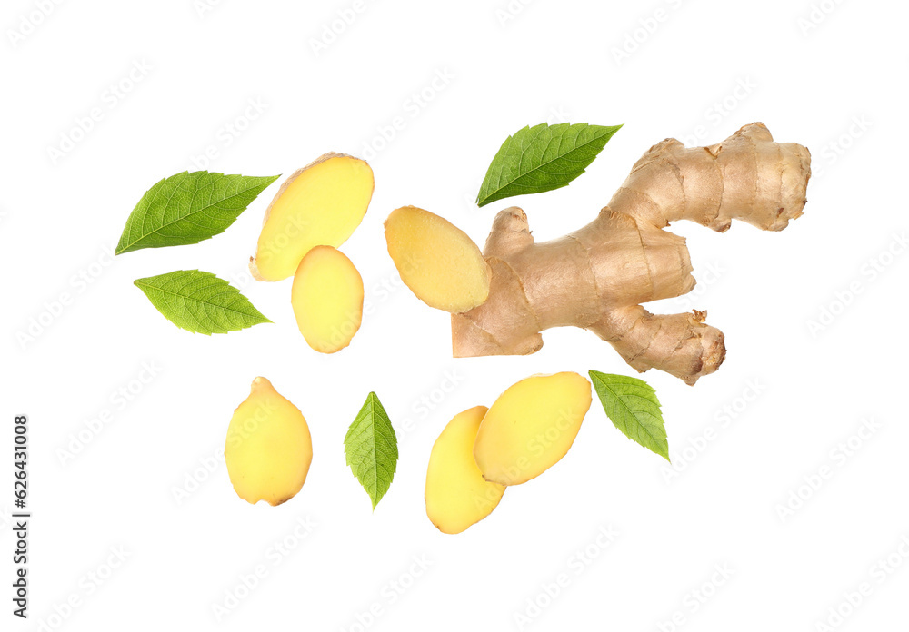 Flying slices of fresh ginger roots and leaves on white background