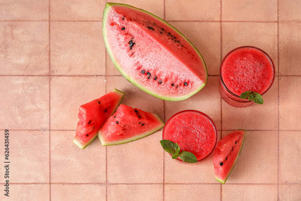 Glasses of tasty watermelon juice with mint on pink tile table