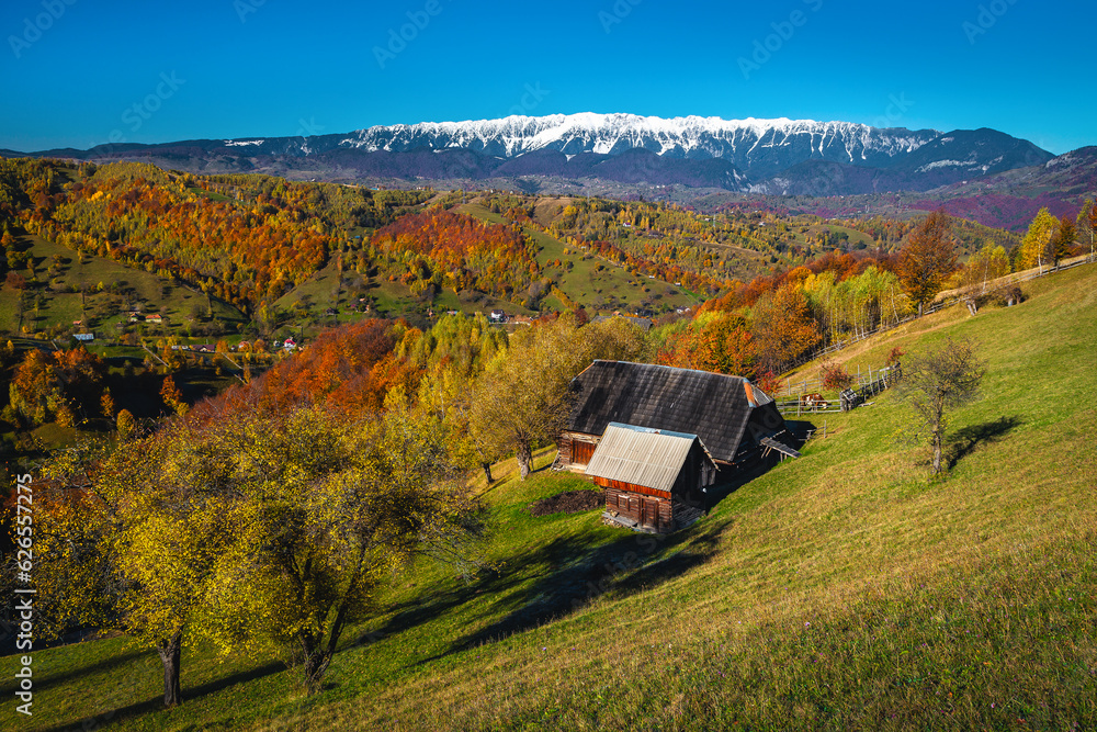 Spectacular countryside autumn scenery and wooden house on the slope