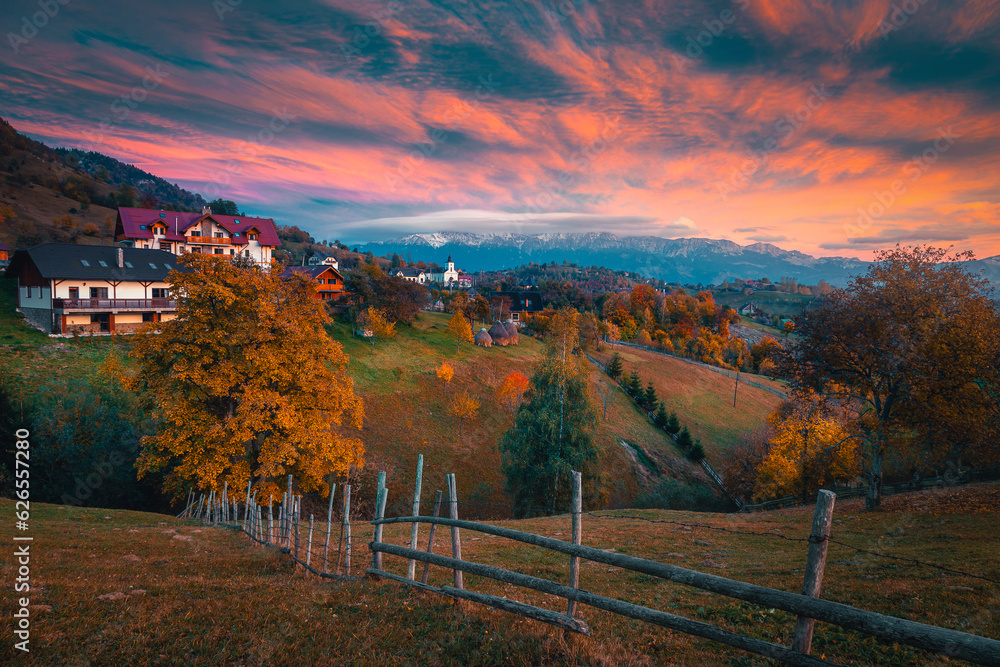 Small alpine village on the hill at sunset, Romania