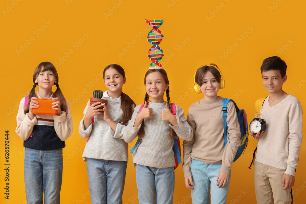 Little pupils with backpacks on yellow background