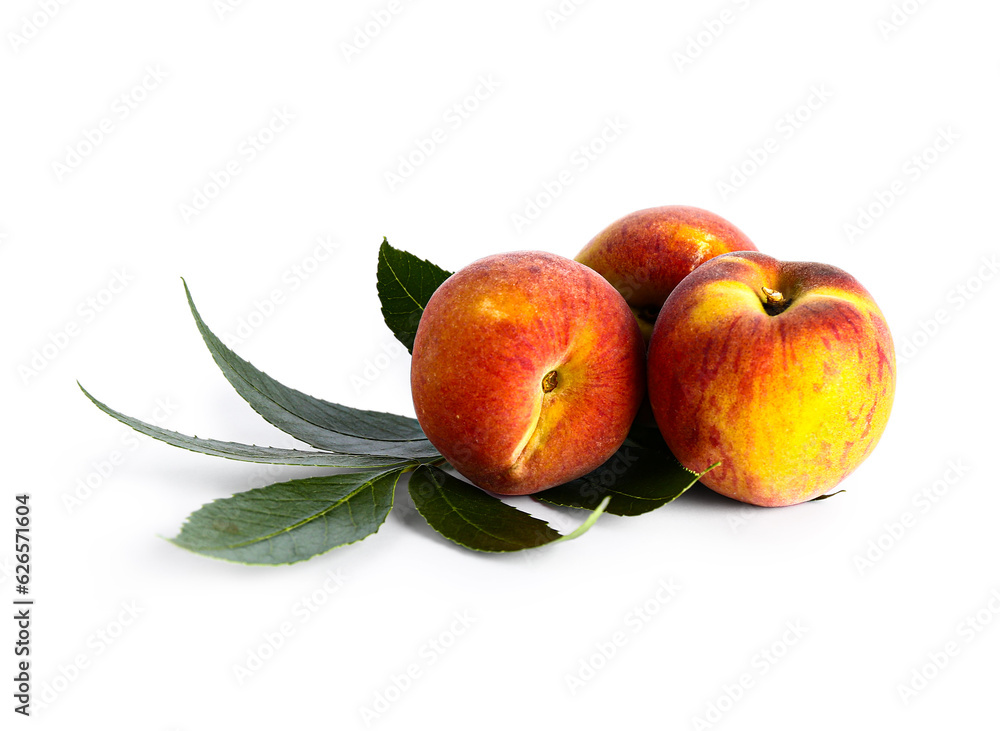 Sweet peaches and leaves on white background